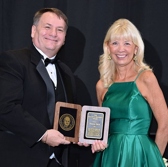 Donna Haye next to Dean Leo Kempel holding her award.