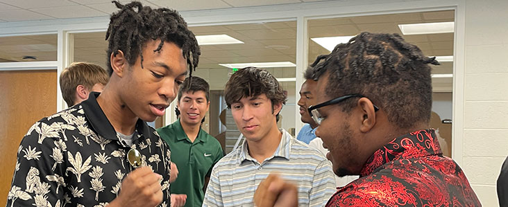 ESSA 2023, two students playing "Rock, Paper, Scissors"