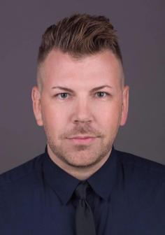 Professional headshot of Alex Delavan