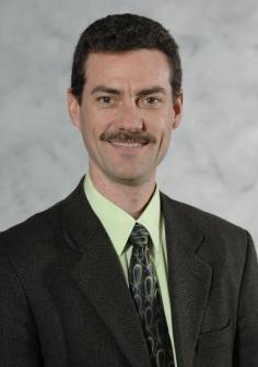 Professional headshot of Tim Hogan