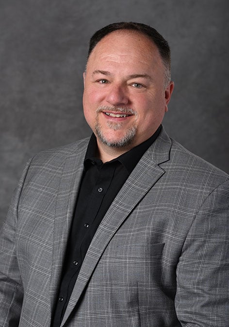 Professional headshot of Andrew Mason