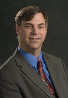Professional headshot of Charles Owen