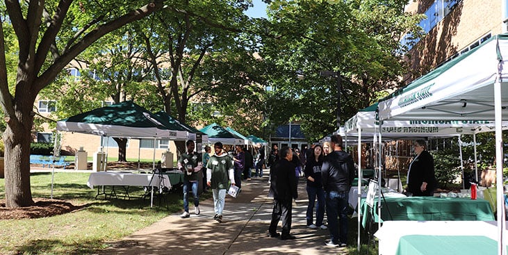 tents set up in the courtyard of Engineering, perspective students are there talking to people at the booths