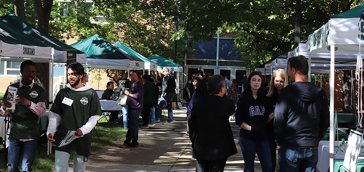 tents set up in the courtyard of Engineering, perspective students are there talking to people at the booths