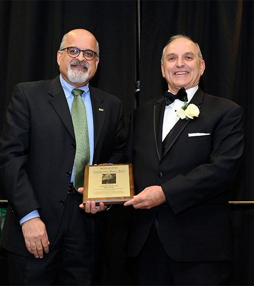 Among his roles, Neeraj Buch celebrated the department's graduates. Here, he presents the Distinguished Alumni Award to Larry Fleis, P.E.