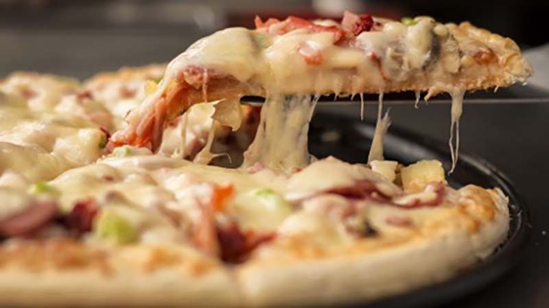 Photo of cheesy pizza slice