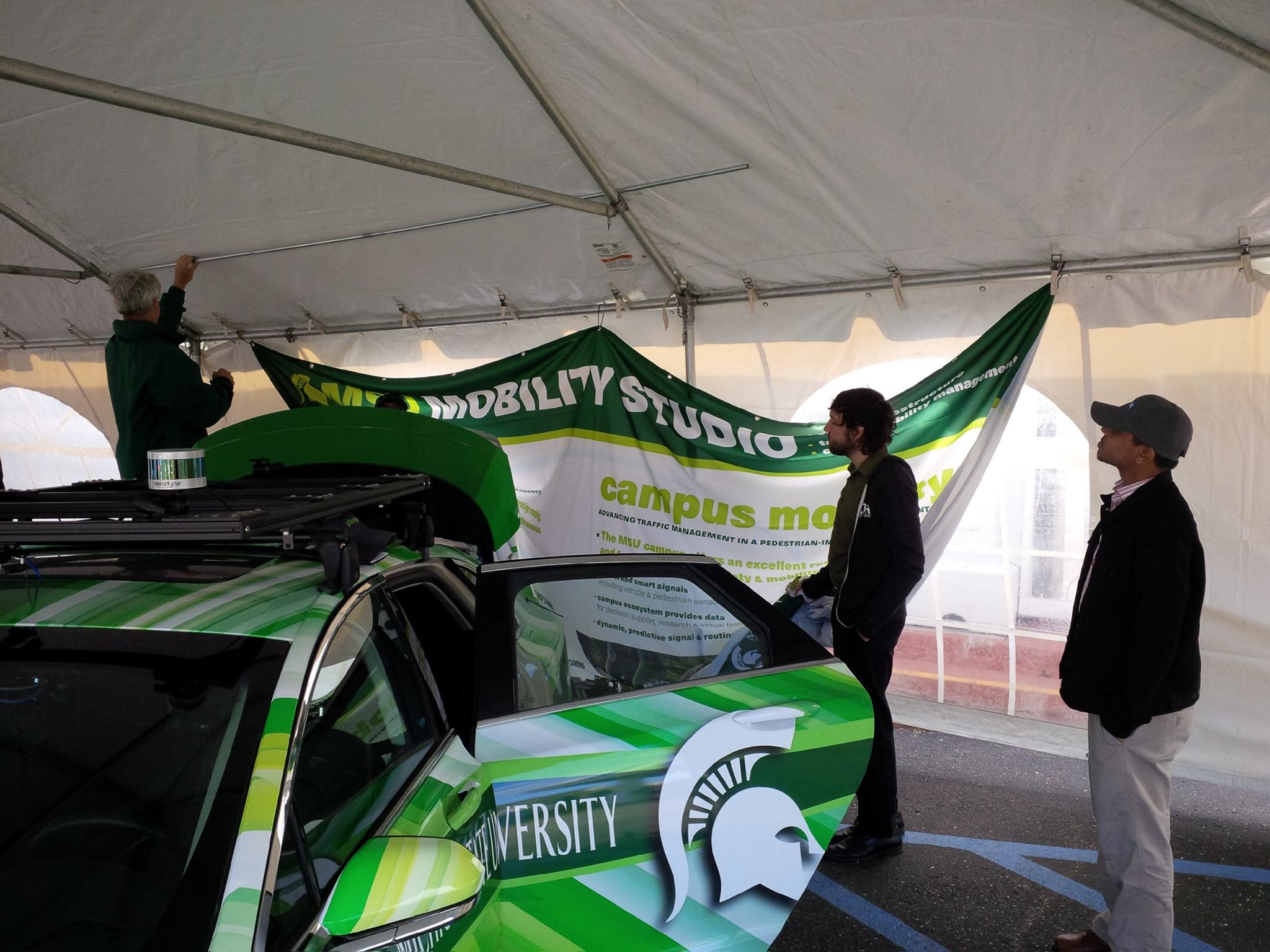On the dock -- the tent set up gave MSU Engineering a chance to show off its autonomous advances in computer vision, radars, antennas, and high-assurance computing, along with a very cool green and white car!