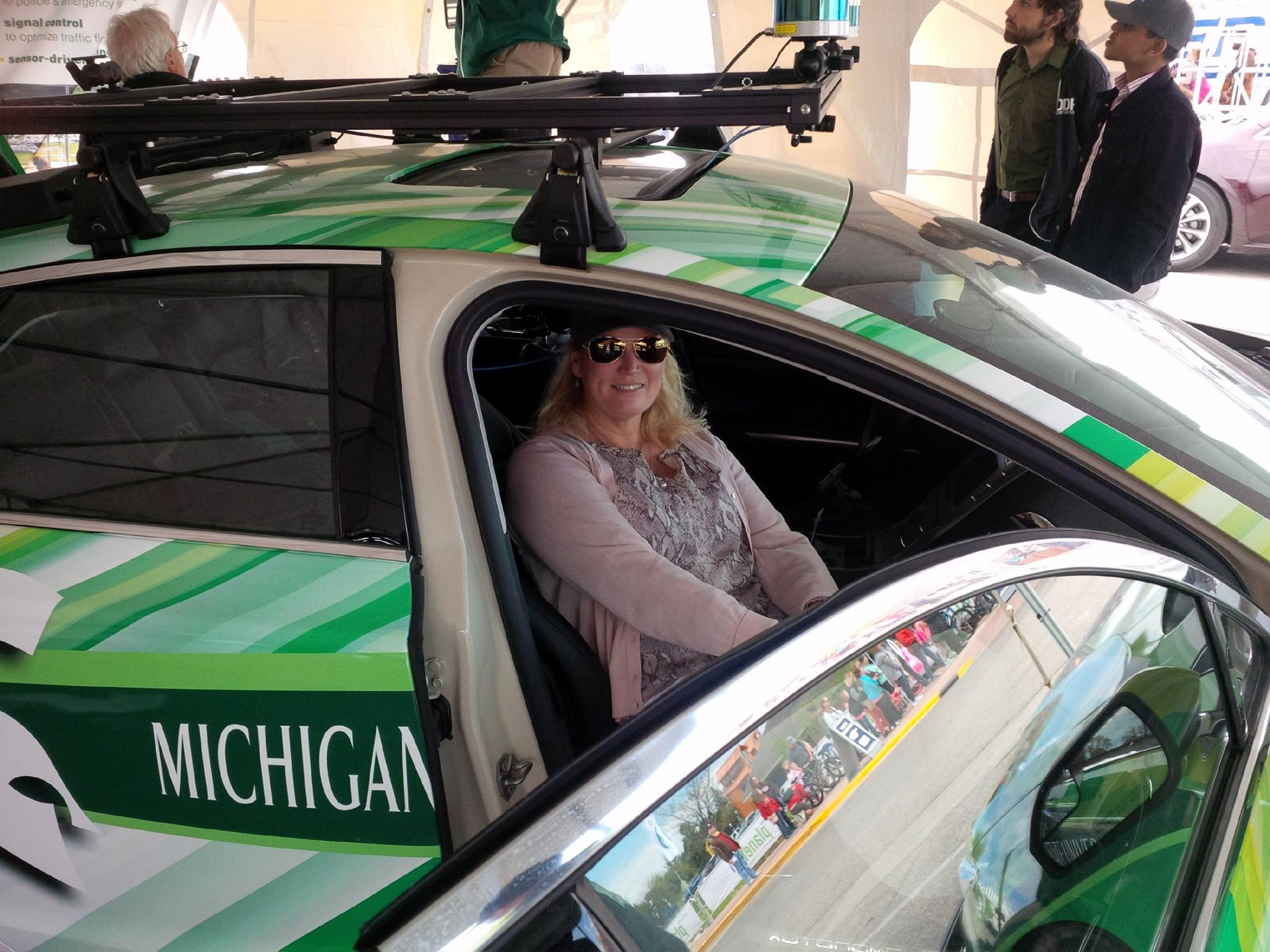 Michigan's two largest universities had autonomous tech on display on Shepler's Ferry dock in Mackinaw City, each drawing loyal alums -- like Spartan Patty Shepler.