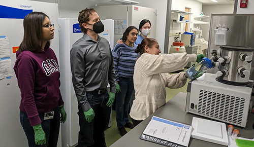 Photo of professor and students in a lab