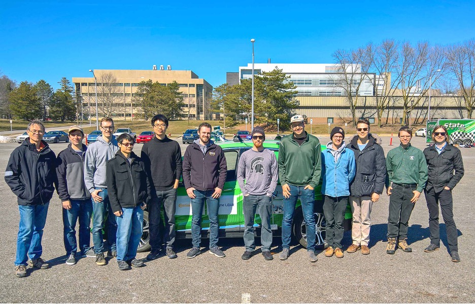 A photograph of the Student Organized Autonomy Research Group, or SOAR, and other MSU autonomous vehicle researchers. Associate Professor Daniel Morris is at the far left. Credit: Courtesy of SOAR