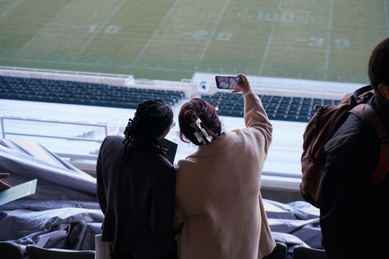 two students taking a selfie in the Spartan Stadium at the Dean's Showcase of Stars