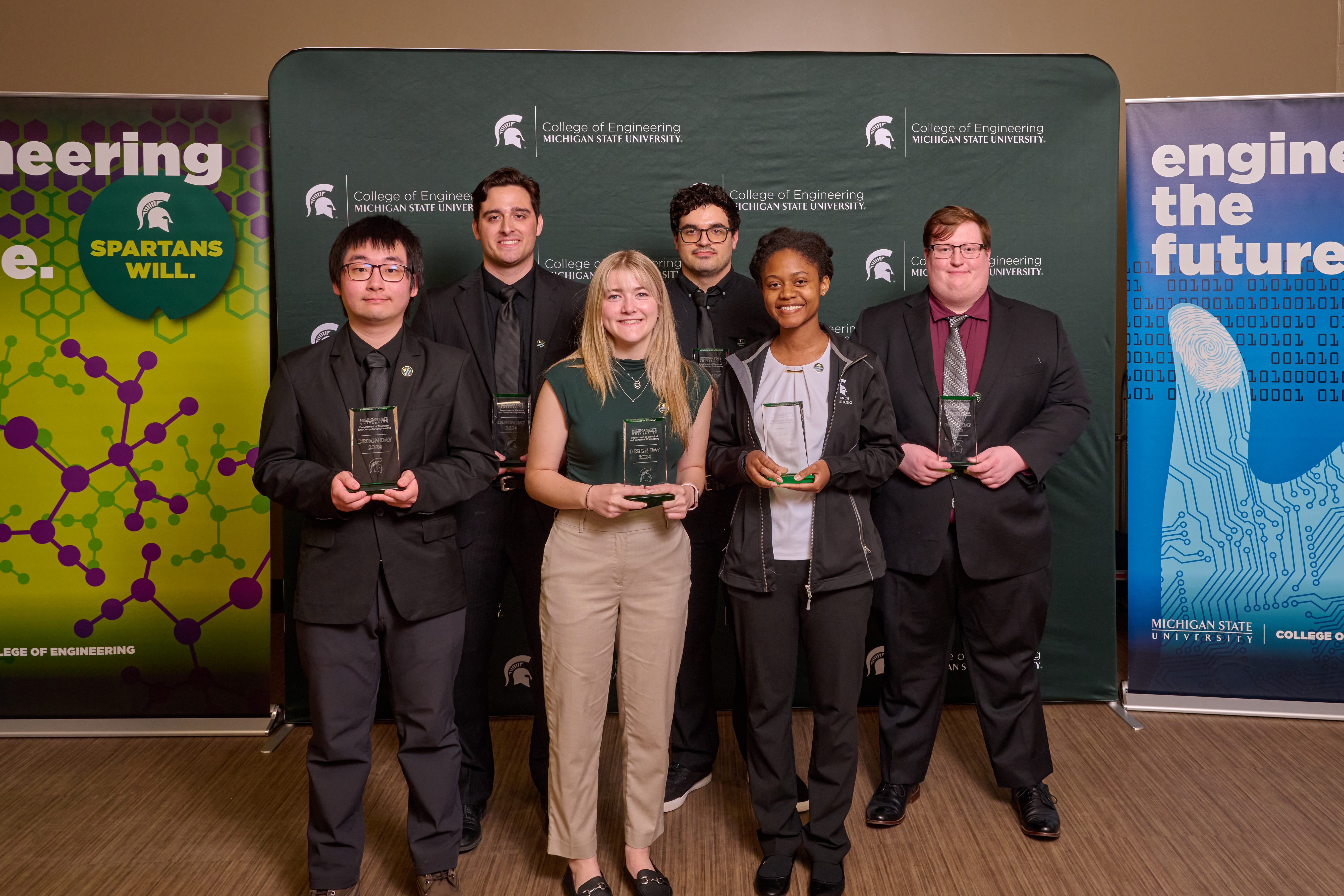A diverse group of students showing off their awards at Design Day