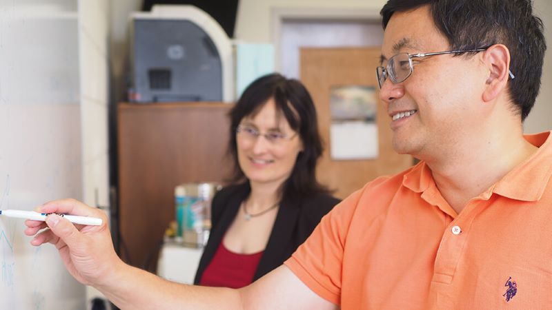Xuefei Huang (right) of Michigan State University and Nicola Pohl (left) of Indiana University, Bloomington discuss carbohydrate chemistry during Pohl’s visit to MSU.