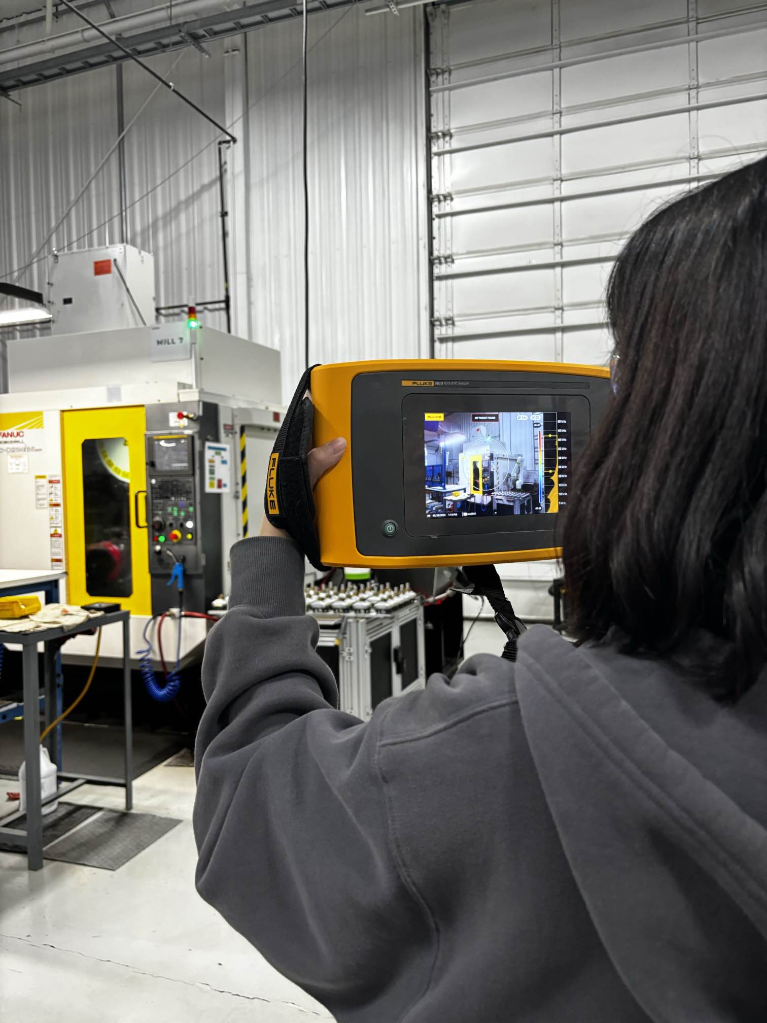 Luyao Yuan, a doctoral student in environmental engineering, uses an ultrasonic leak detector to locate and measure leaks in compressed air systems