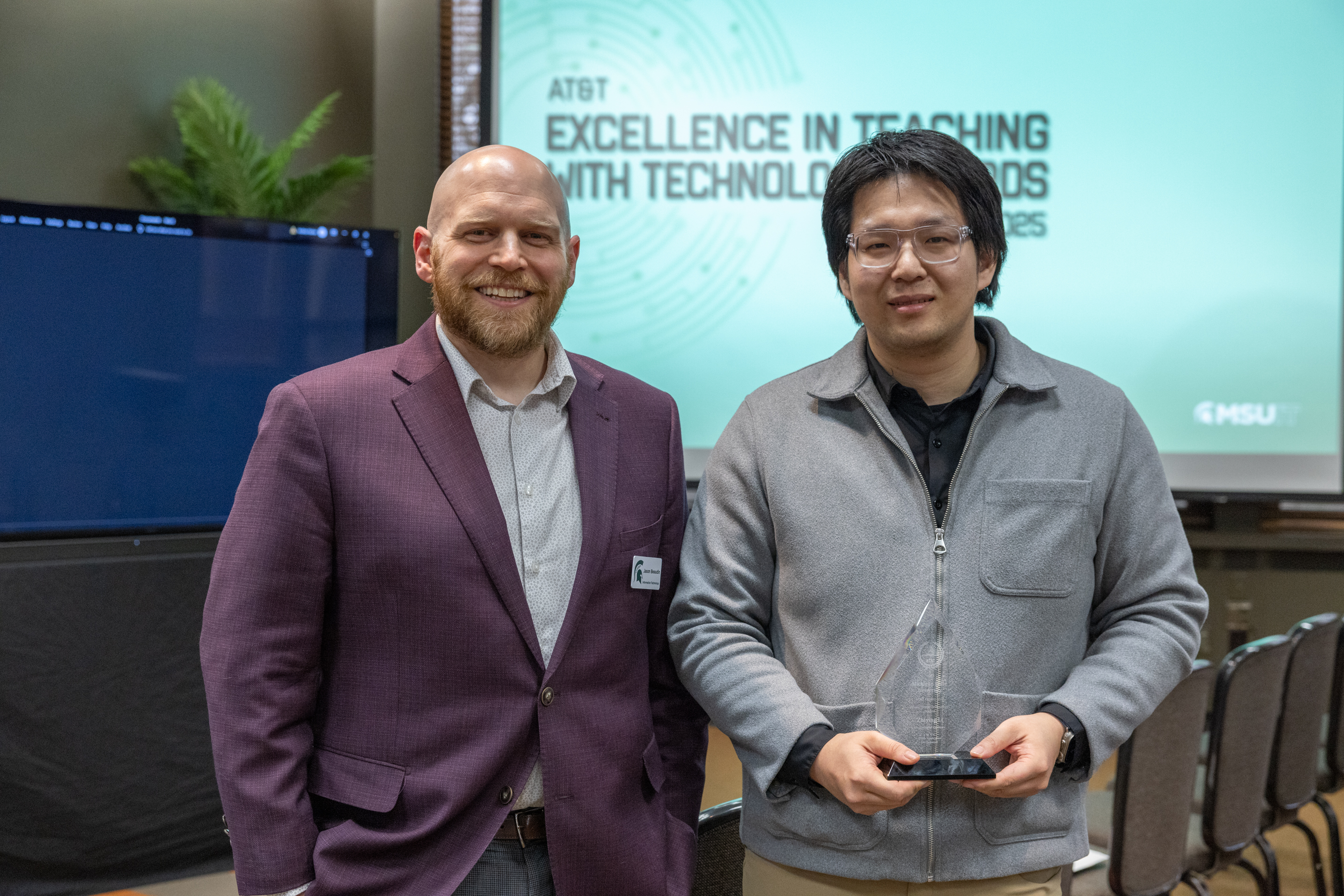 Jason Beaudin, Executive Director for Educational Technology presents the AT&T Excellence in Teaching with Technology Award to Zhiying Li.