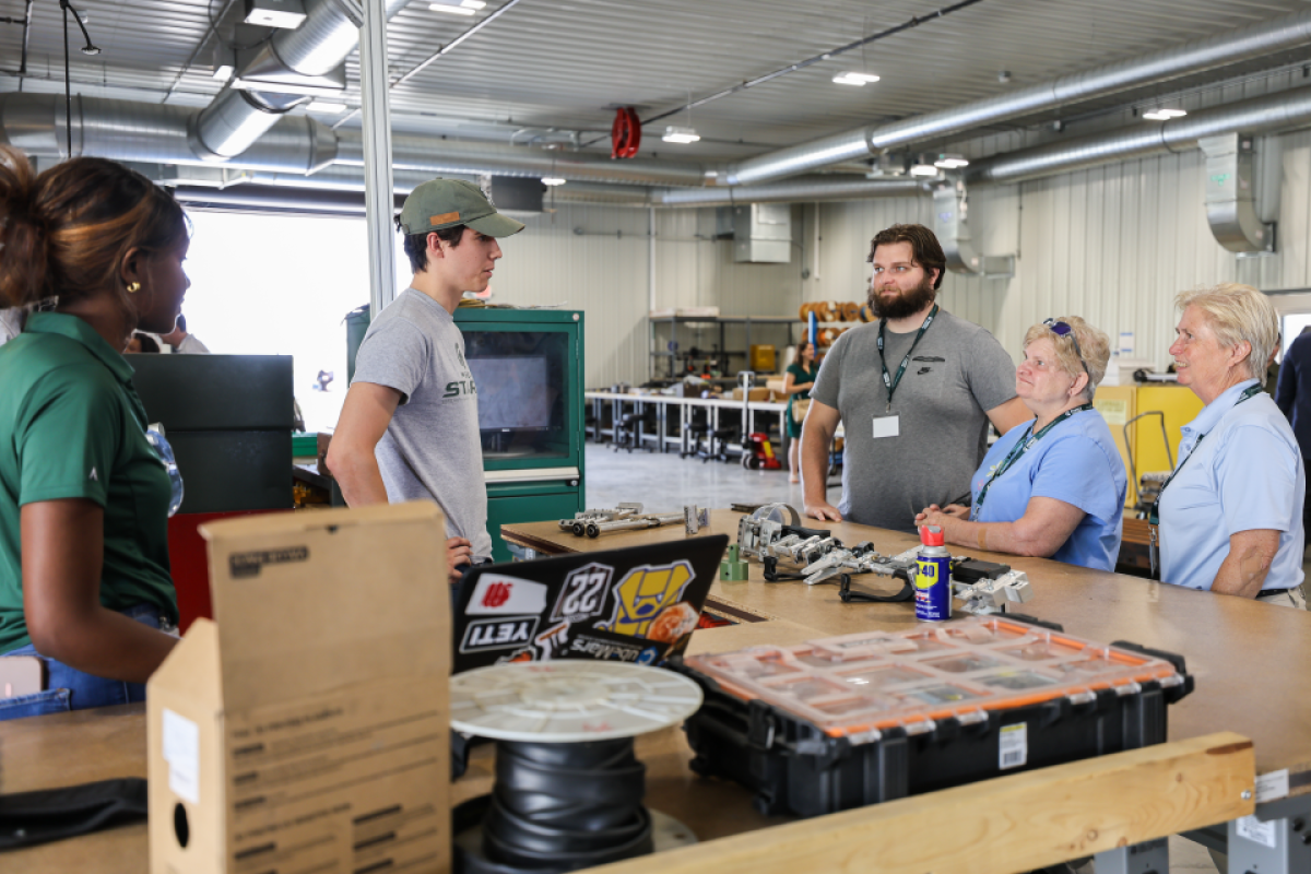 The StarX team shows off parts of their exoskeleton.