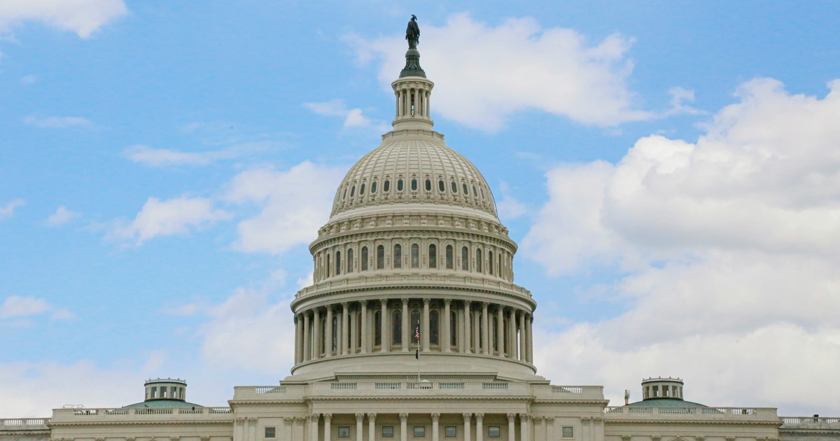 The U.S. Capitol Building against a blue sky.