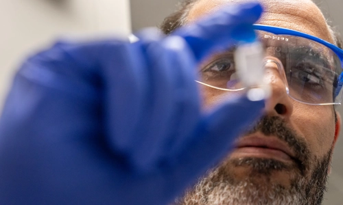 Researcher holding a tube