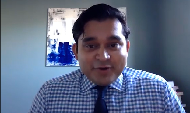 Male professor speaks in his office. 