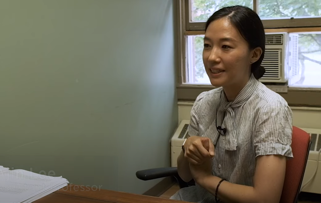 Female professor speaks in her office. 