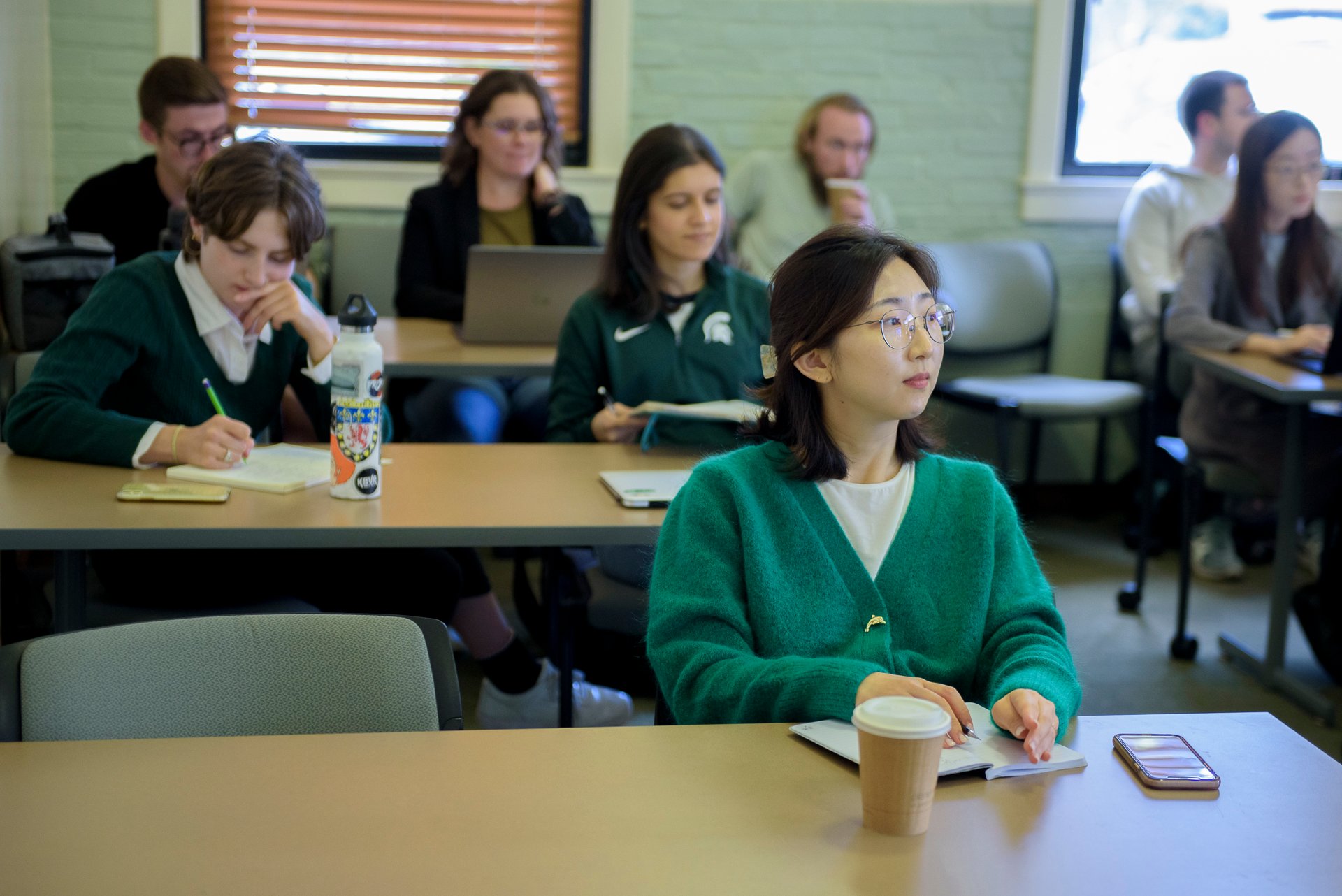 Students take notes during a seminar.