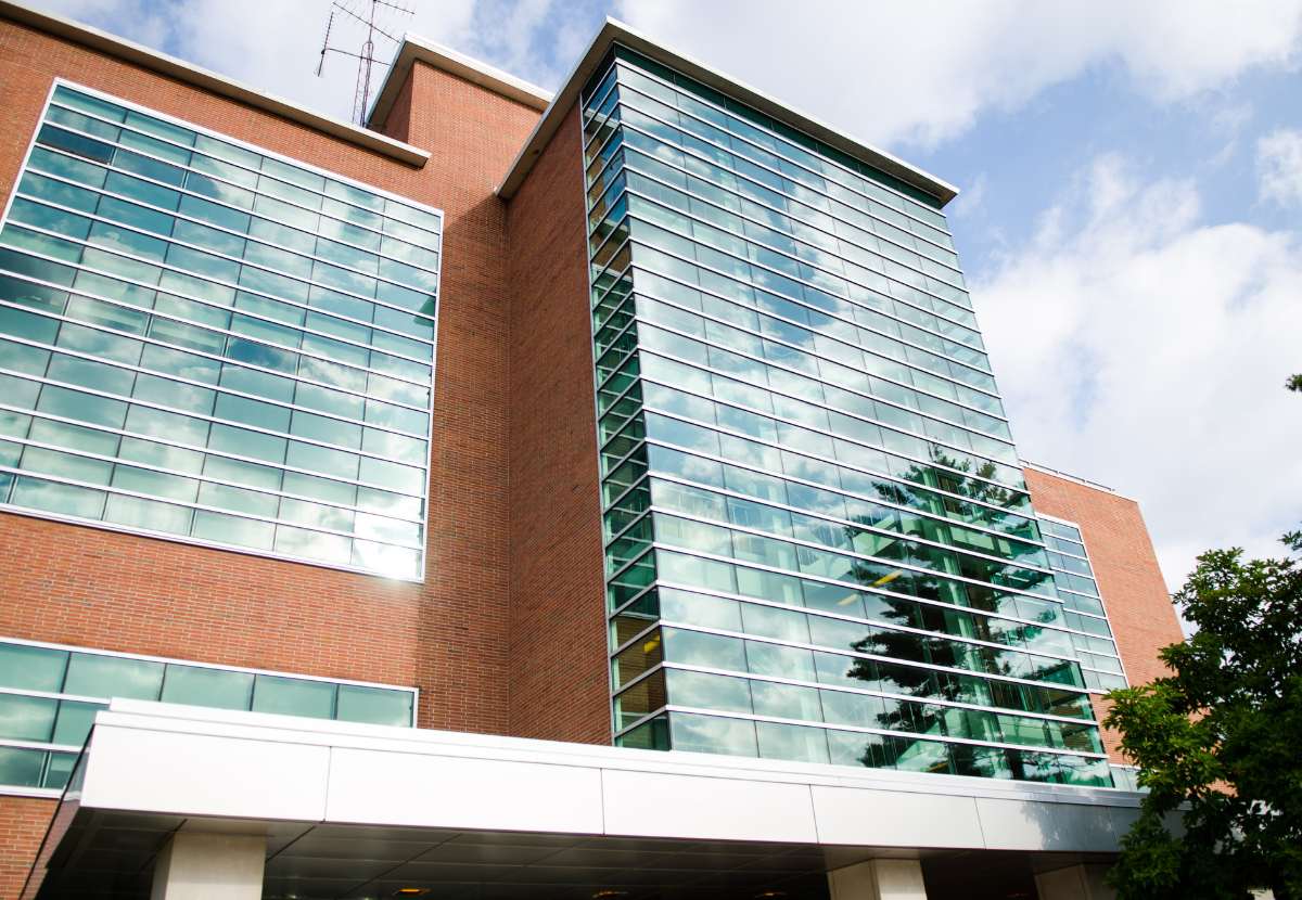 Erickson Hall, one of the buildings for the MSU College of Education. Erickson Hall is 5 stories tall and primarily comprised of reddish brick and horizontal glass windows.