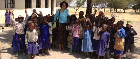 Professor Amita Chudgar stands with young learners.