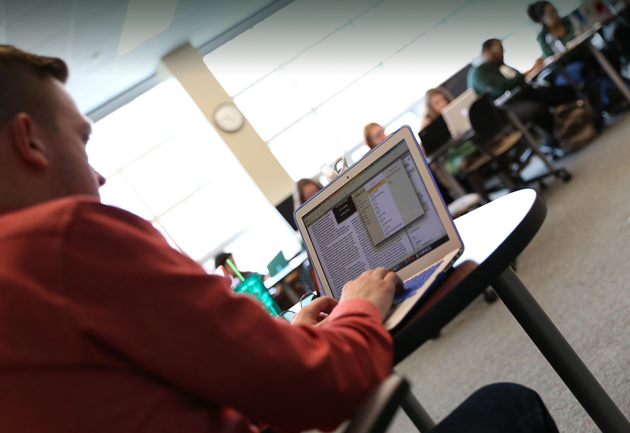 Student types on a computer during class