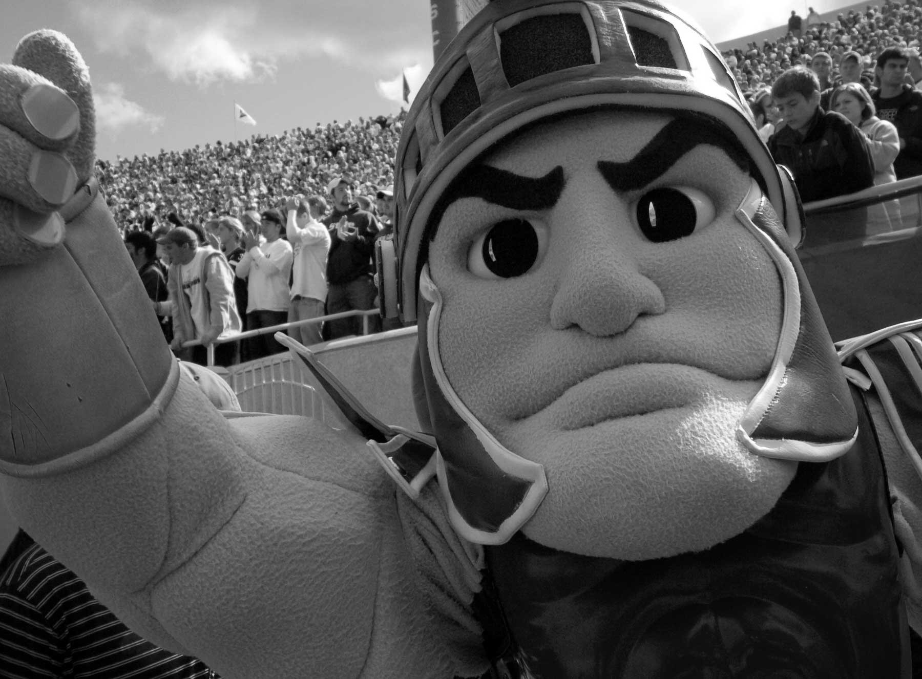 black and white photo of Sparty at a football game
