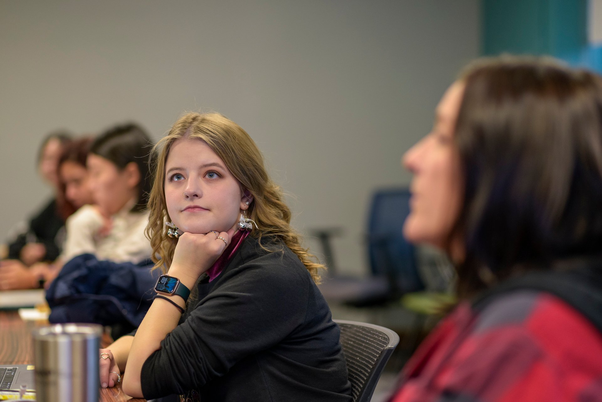 A graduate student listens to a faculty member. 