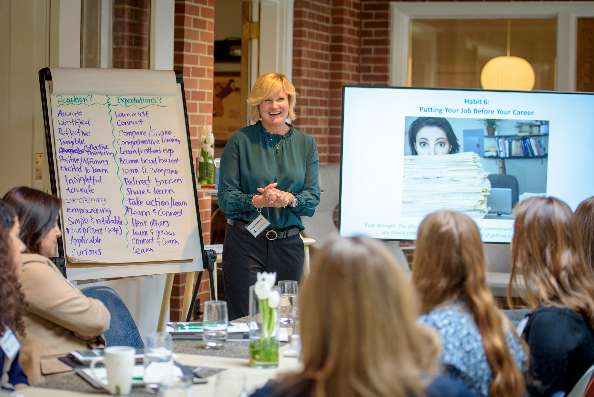 Woman leader presents on career opportunities to a group of women students.