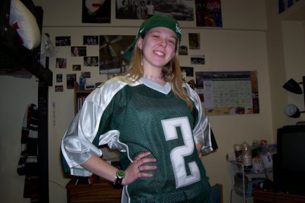 Neidert photo from her time at MSU smiling and wearing a green jersey.