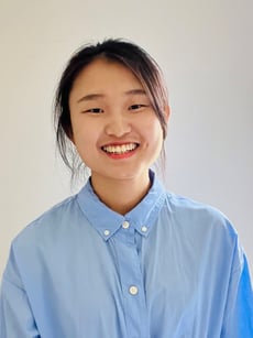 Headshot of Qi Huang.