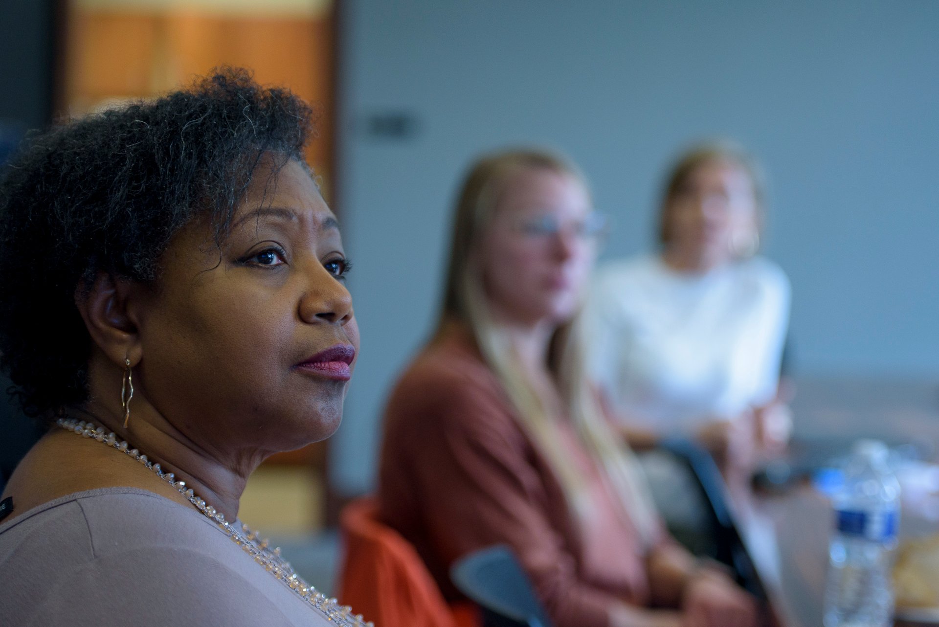 Women faculty members speaking to each other.