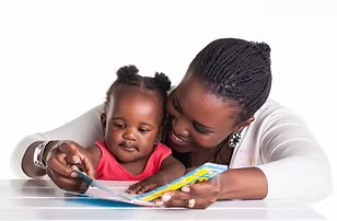 Twelve month old reads with mother.