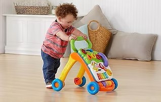 Twelve month old walks with baby walker.