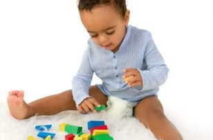 Fifteen month old playing with blocks.