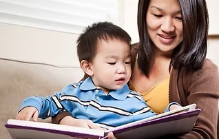 Fifteen month old reading with mother.