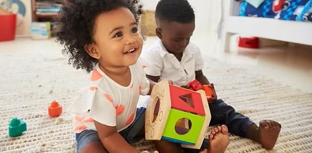 Eighteen month olds playing with toys.