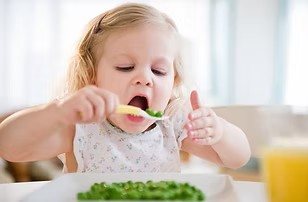 Two year old feeds herself.