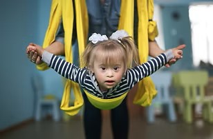 A child doing aerial yoga.