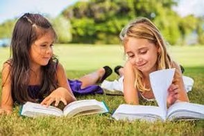 Seven year olds reading in the yard.