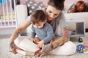 Nine month old held by mother.