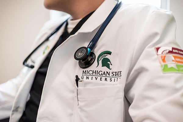 doctors with stethoscope and multicolors patch on left arm 
