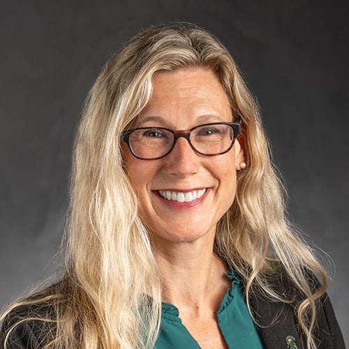 Headshot of Laura Lee McIntyre with a dark gray background.
