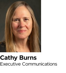 Headshot of Cathy Burns, executive communications, on a gray background.