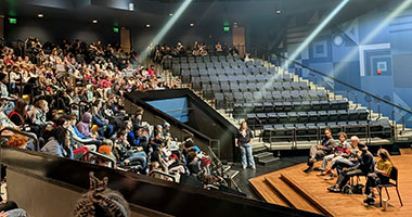School-aged students attend a panel discussion with performers from a Wharton Center show