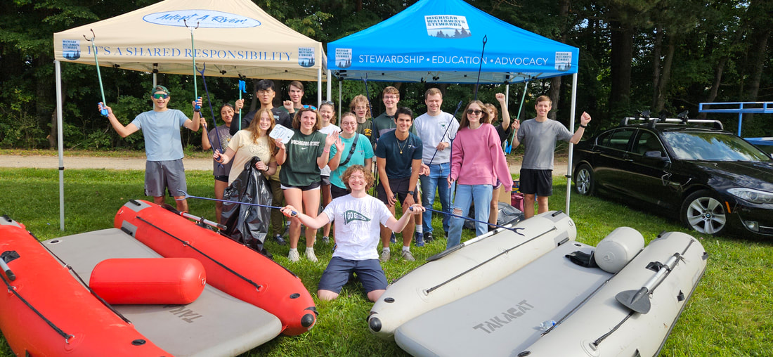 Group shot of MSU Crew Club members outside preparing for a river cleanup event.
