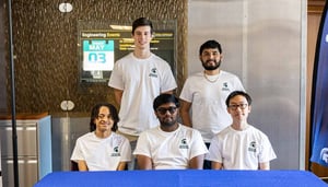 Five scholarship students smile at the camera.