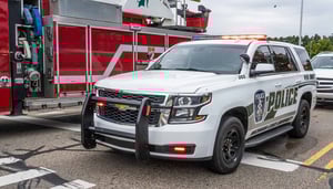 An MSU Police car is parked in front of a fire truck.
